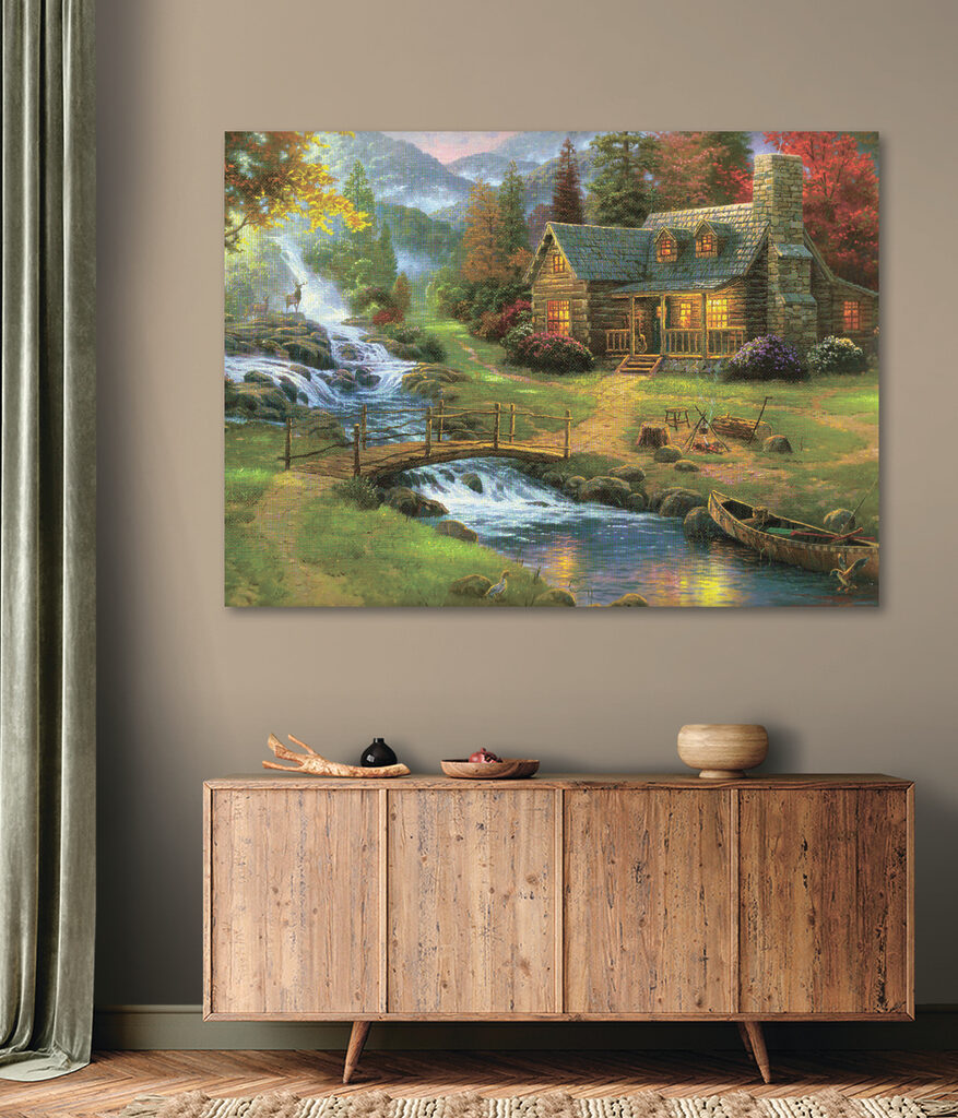 A painting of a log cabin with a bridge over a river