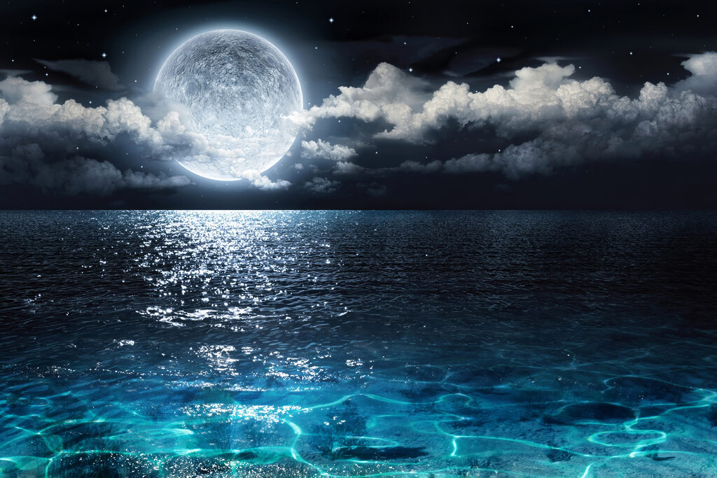 A moon over water at night A moon over water at night