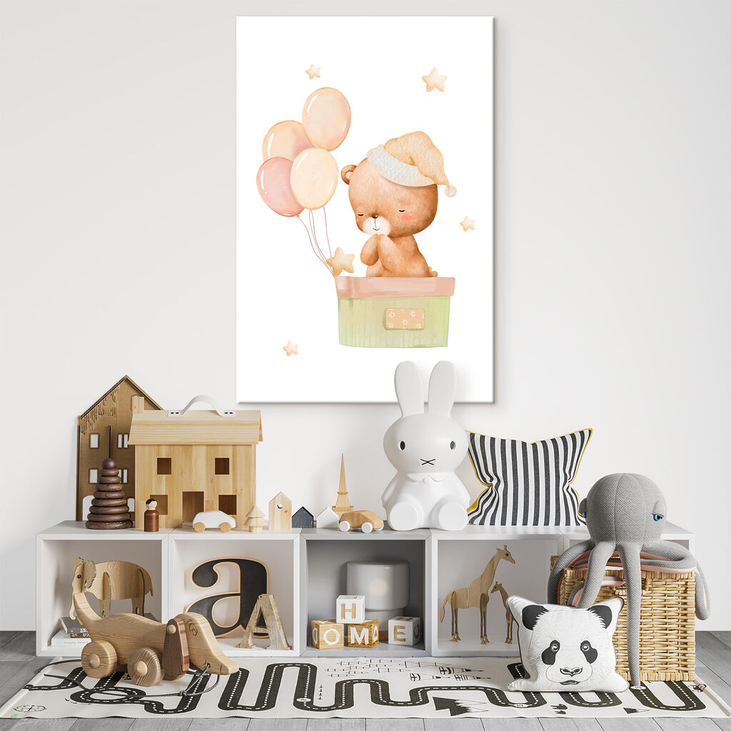 A teddy bear in a box with balloons