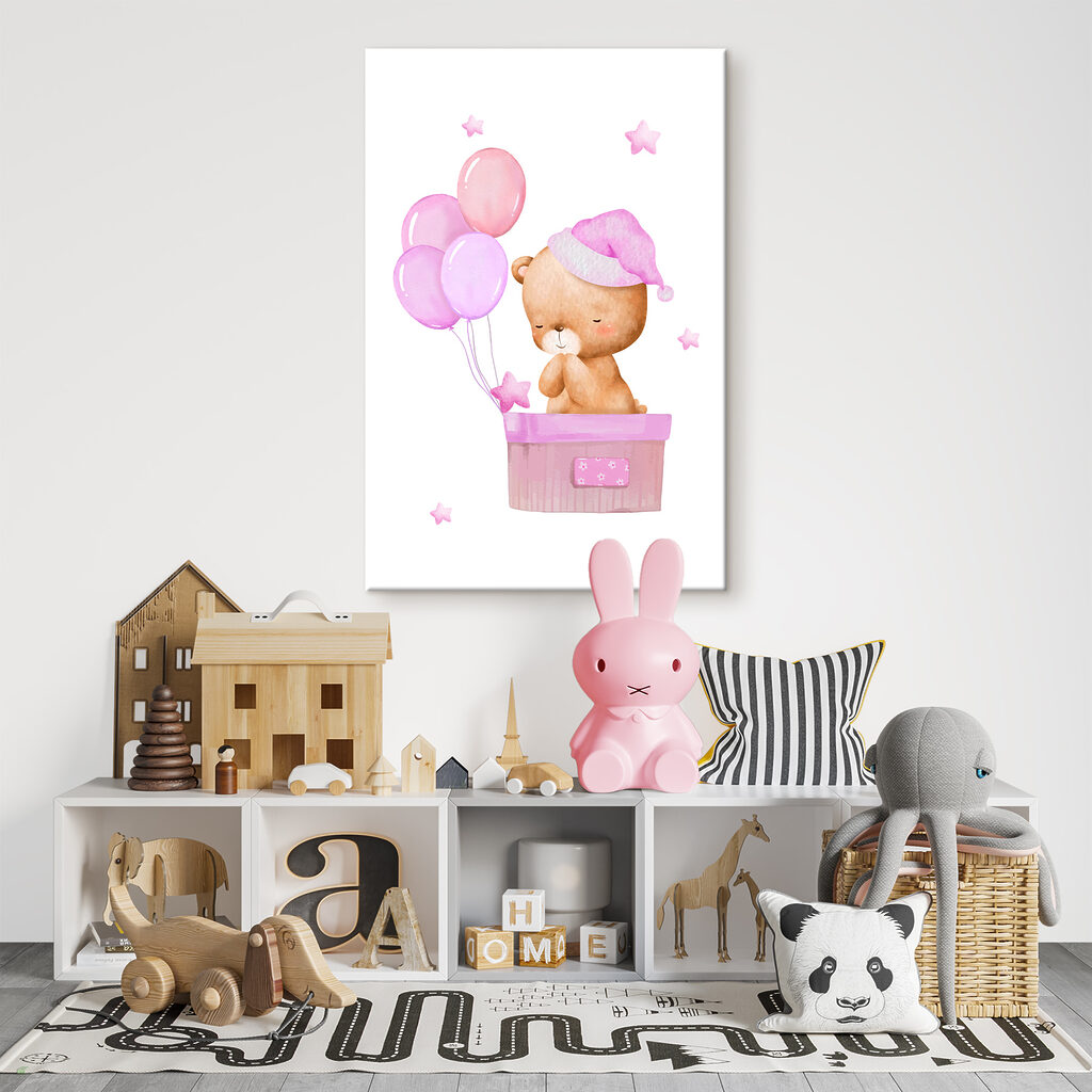 A teddy bear in a basket with balloons