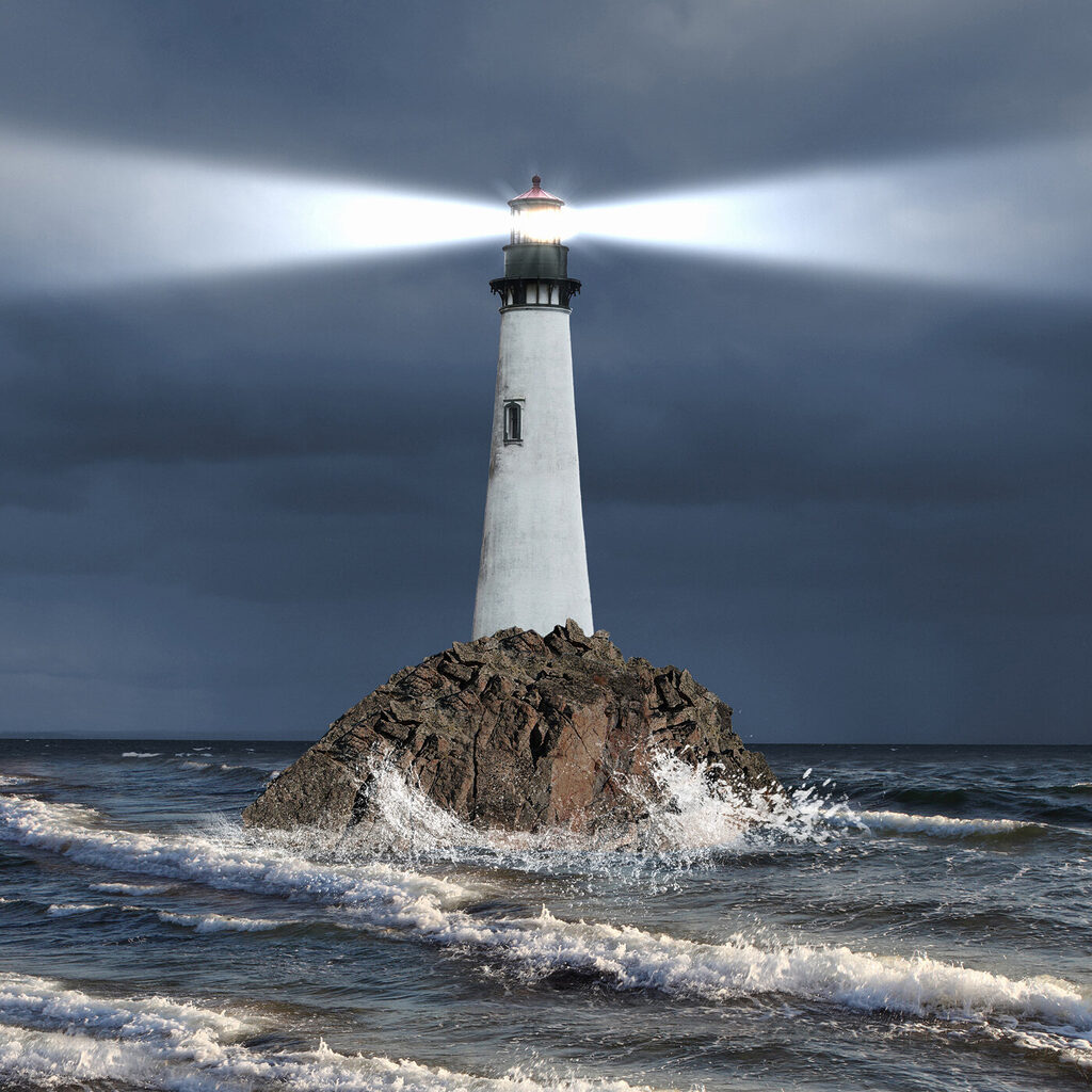 A lighthouse on a rock in the ocean A lighthouse on a rock in the ocean