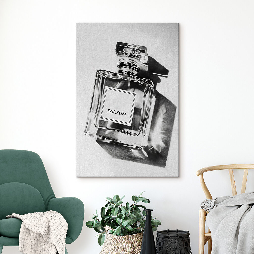 A black and white photo of a bottle of perfume