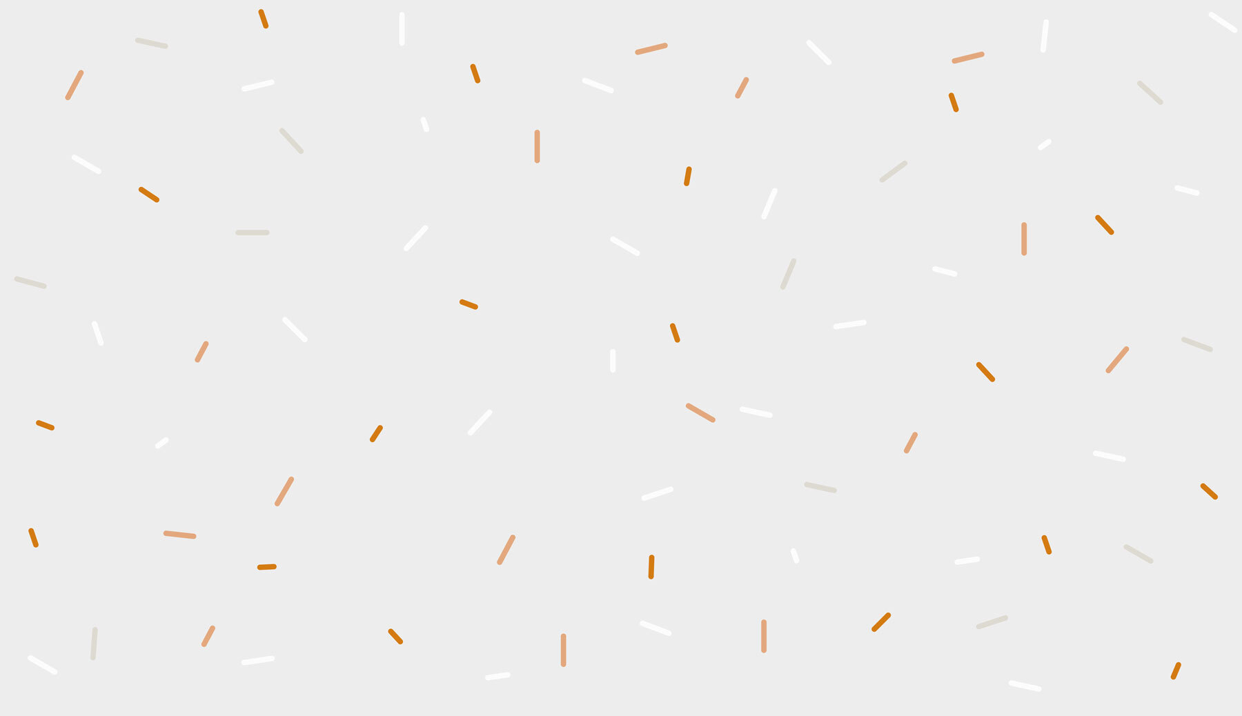 A white and orange sprinkles on a gray background