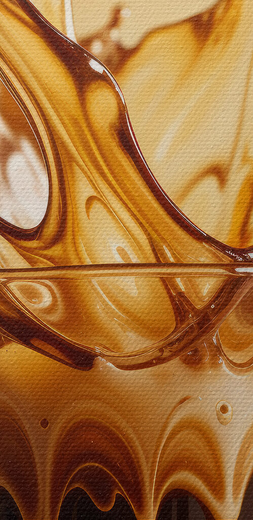 Glass of liquid with brown liquid splashing out