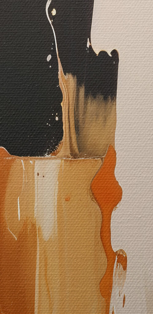White and orange paint dripping down a black surface