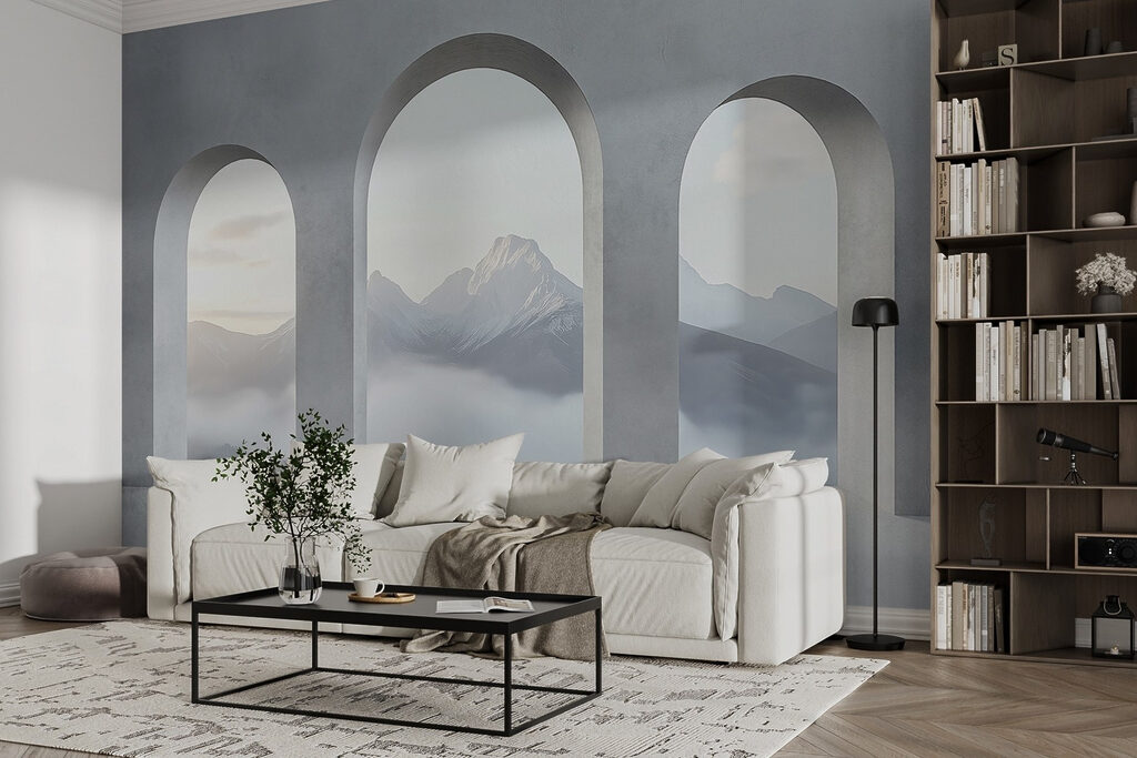 White room with arched windows and mountains in the background