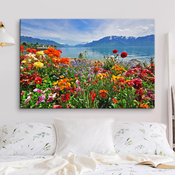 Canvas prints Flower bed with flowers and a lake in the background Canvas prints Flower bed with flowers and a lake in the background