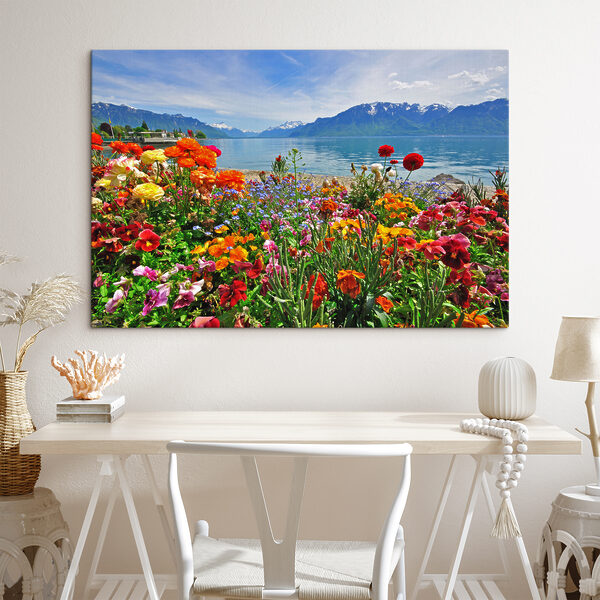 Canvas prints Flower bed with flowers and a lake in the background Canvas prints Flower bed with flowers and a lake in the background