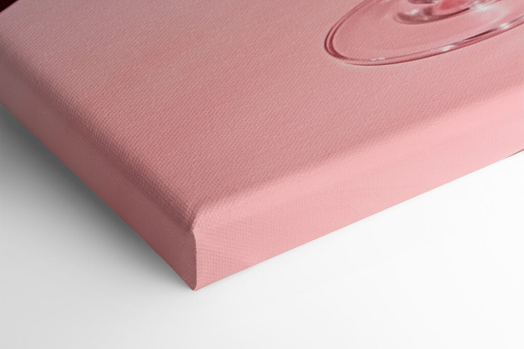 Glass with pink liquid and two cherries on it