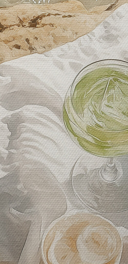 Picnic basket and glasses of wine on a rock by water