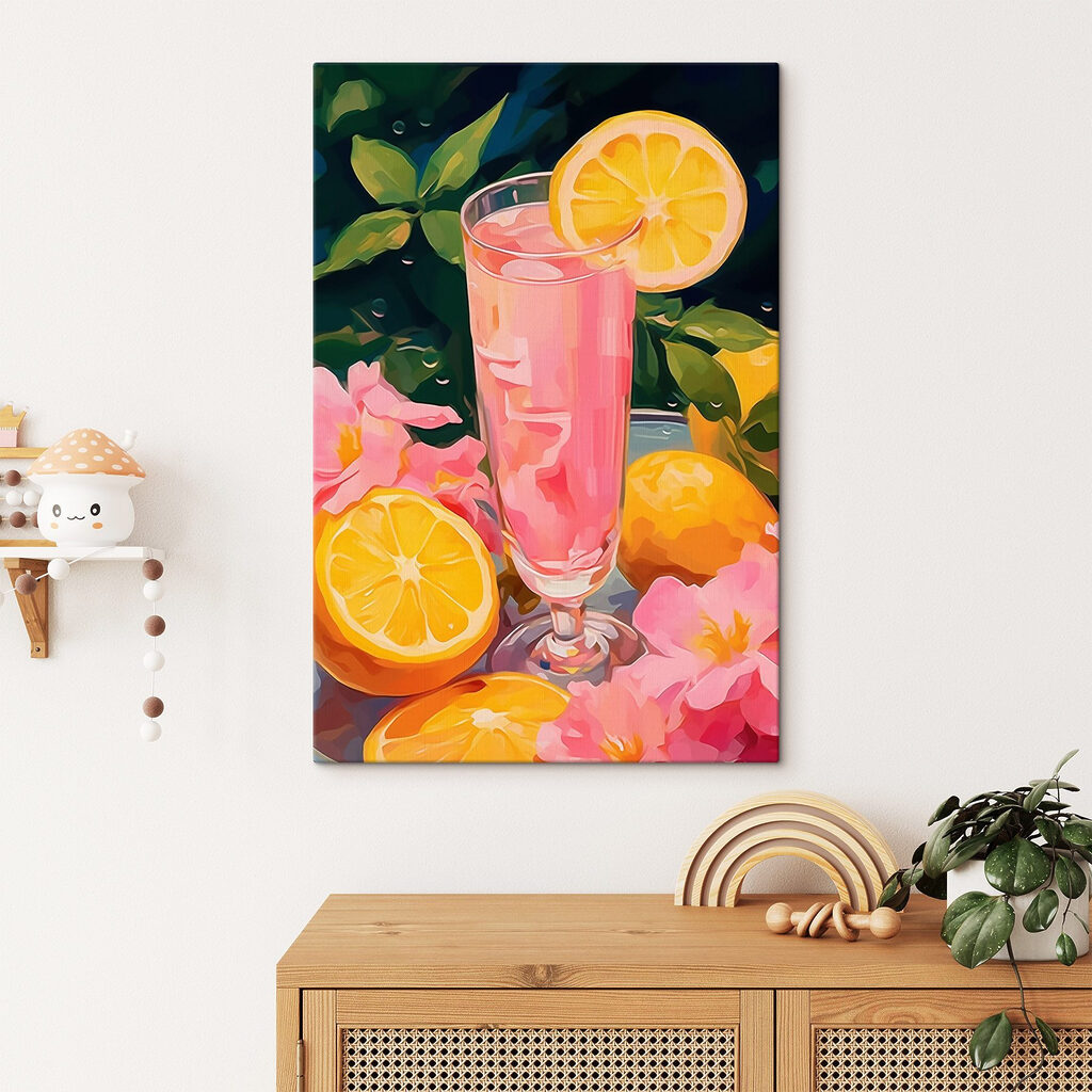 Glass of pink liquid with lemons and flowers
