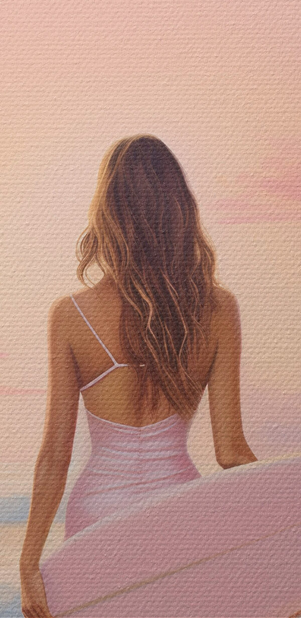 Woman in a swimsuit holding a surfboard on a beach