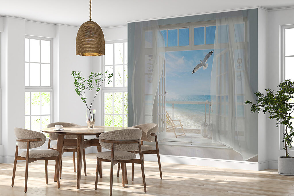 View of a beach from a room with a bird flying over it View of a beach from a room with a bird flying over it