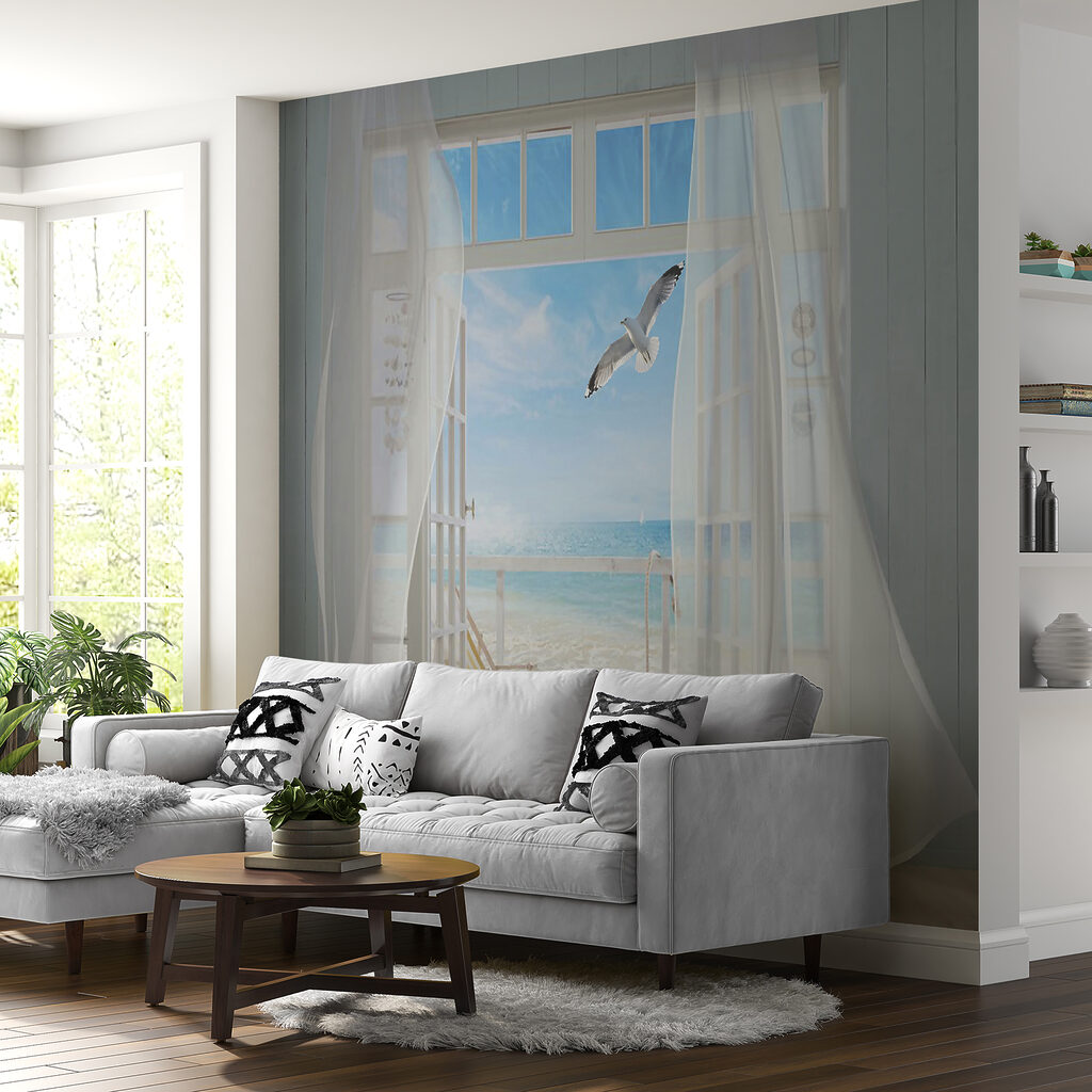 View of a beach from a room with a bird flying over it View of a beach from a room with a bird flying over it