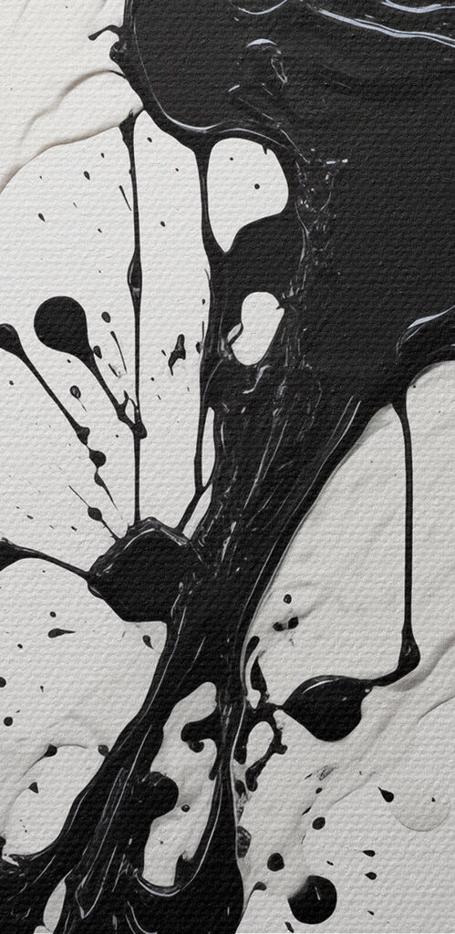 Black and white paint splattered on a white surface