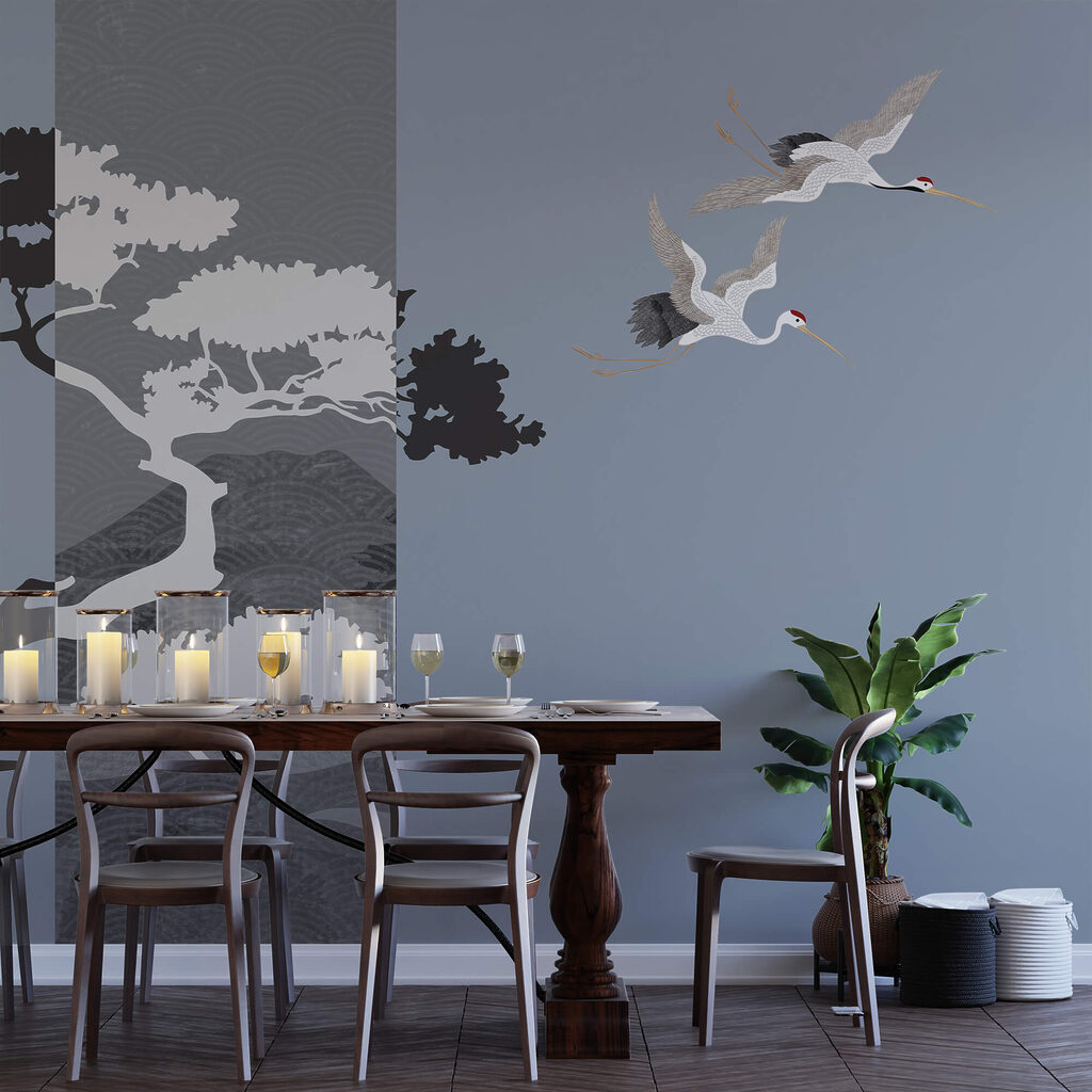 Para żurawi lecących obok drzewa