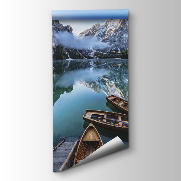 Boats on a lake with mountains in the background