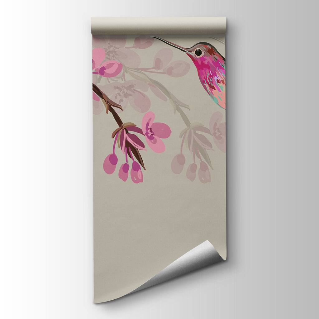 A bird flying next to a branch of flowers