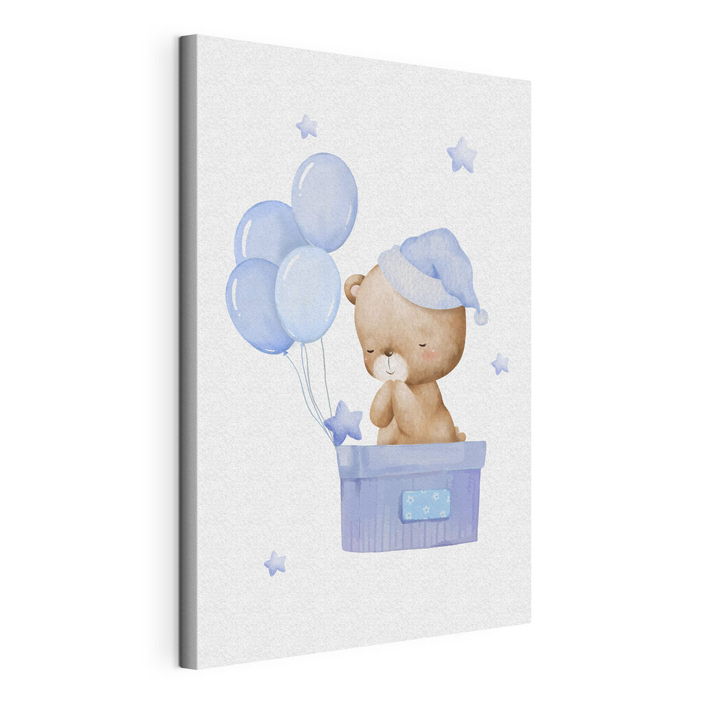 A teddy bear in a box with balloons