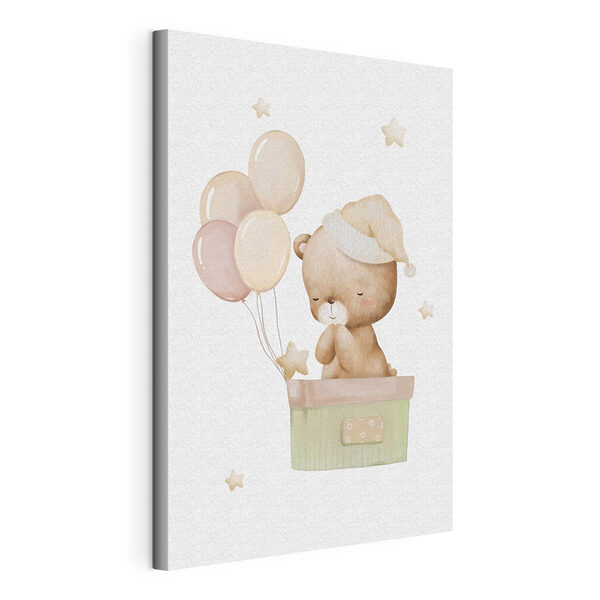 A teddy bear in a box with balloons