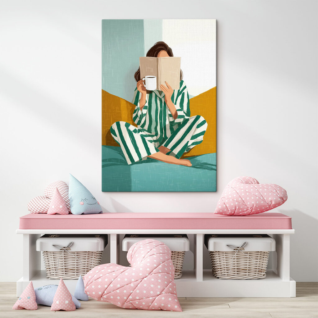 Woman sitting on a bed with a book and a mug